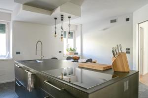 a kitchen with a sink and a counter top at Casa Riccardo in Levico Terme