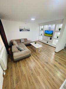 a living room with a couch and a table at Muki apartments in Surčin