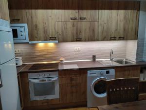 a kitchen with a sink and a washing machine at Ca de Callet - planta baixa in Taull