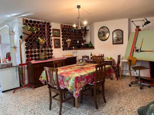 a dining room with a table and a wine cellar at Casa fra gli ulivi di Giuseppe in Sonnino