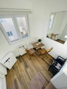 an aerial view of a living room with a table and chairs at Muki apartments in Surčin