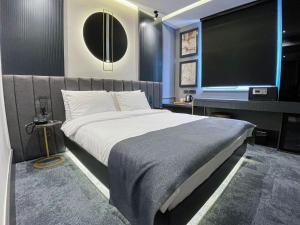 a bedroom with a large bed and a flat screen tv at MELLDAY HOTEL 