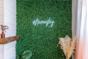 a green wall with the word harmony written on it at 2 King Beds - Free Parking - BBQ - Arcade - Patio in Pittsburgh
