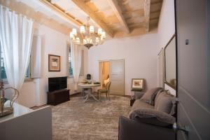 a living room with a couch and a table at Le SUITE del VICOLO in Imola