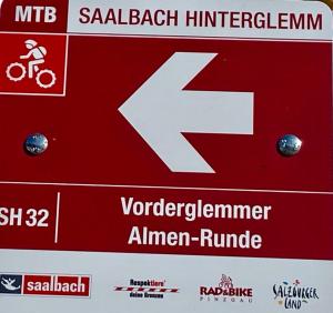 a red and white street sign with the number seven at ALM SEASONS Premium Chalet & Studios in Saalbach-Hinterglemm +39 photos