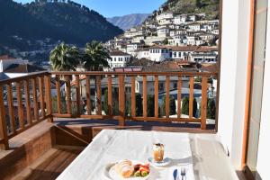 un tavolo con un piatto di cibo su un balcone di Hotel Rezidenca Desaret a Berat