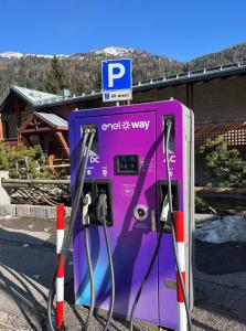 a purple gas pump sitting in a parking lot at Residence Orsa Maggiore in Madonna di Campiglio