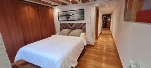 a bedroom with a white bed in a room at Fisherman's house Bermeo in Bermeo