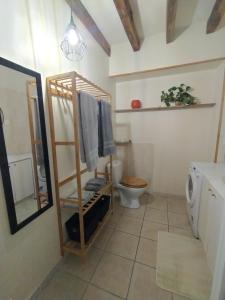 a bathroom with a toilet and a towel rack at Gite du vieux cèdre in Écueillé