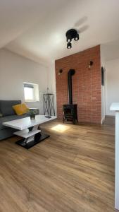 a living room with a couch and a fireplace at Apartament Loft in Elblag