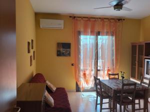 a living room with a table and a dining room at Casa Vacanza Da Rosa in Letojanni