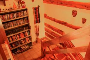 a room with a book shelf filled with dvds at Hosteria Al Paraiso in Villa Pehuenia