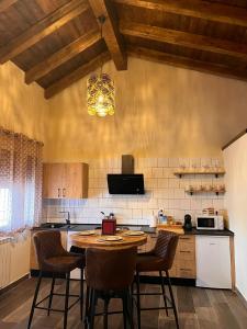 a kitchen with a table and chairs in a room at Casas del Barranco de la Hoz in Ventosa