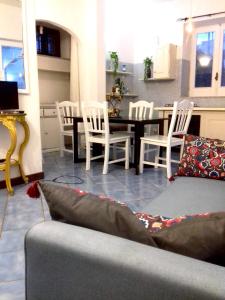 sala de estar con sofá, mesa y sillas en Casa vacanza maronti en Ischia