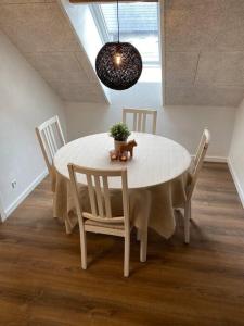 a white table with chairs and a teddy bear on it at 2 værelses lejlighed - 1 in Kolding