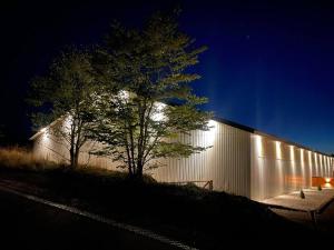 a building with lights on the side of it at night at 2 værelses lejlighed - 1 in Kolding