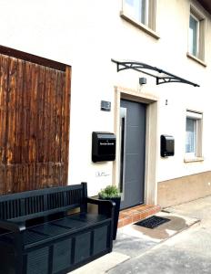 a black bench sitting in front of a house at Ferienwohnung Casa Brandt in Villingen-Schwenningen