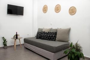 a living room with a couch and a tv at Litmus in Fira