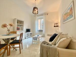 a living room with a white couch and a table at TERMINAL Apartment in Genova