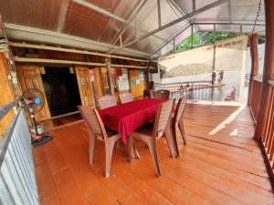 a dining room with a table and chairs on a deck at Anh dược homestay in Bak Kan