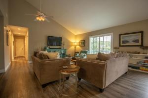a living room with two couches and a ceiling fan at 359 Tarpon Blvd in Fripp Island