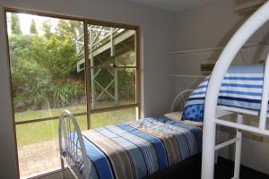 a bedroom with a bunk bed and a window at Sea Banksia in Denmark