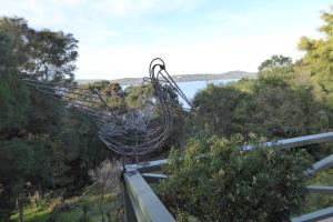 a metal bird sculpture on the side of a building at Sea Banksia in Denmark +2 photos