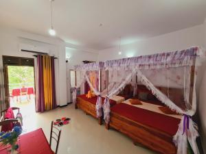 a bedroom with a bed with a canopy at Jungle Lodge in Udawalawe