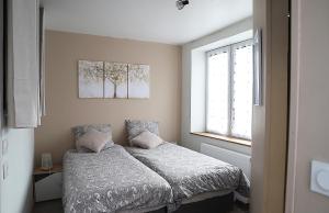1 dormitorio con cama y ventana en L'appart d'Antoine, en Saint-Quentin