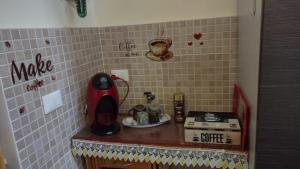 a kitchen with a counter with a stove and a counter top at Casa Primavera in Palermo