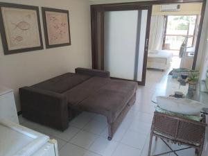 a living room with a couch and a table at Flat a beira mar, vista lateral - Araça 408 in Natal +18 photos