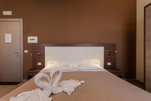 Postel nebo postele na pokoji v ubytování Hotel Don Giovanni