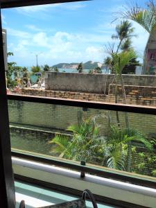 a view from a window of a resort with palm trees at Flat a beira mar, vista lateral - Araça 408 in Natal