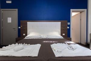 Postel nebo postele na pokoji v ubytování Hotel Don Giovanni