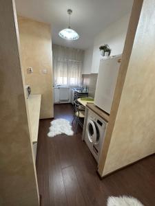 a kitchen with a washer and dryer in a room at Class Apartments in Oradea