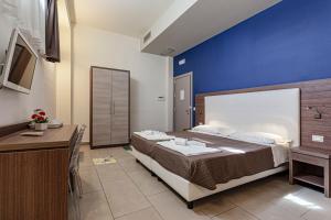 Postel nebo postele na pokoji v ubytování Hotel Don Giovanni