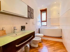 a bathroom with a tub and a toilet and a sink at [Piramide] Luxury Suite Colosseum in Rome