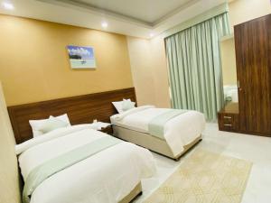 Ένα ή περισσότερα κρεβάτια σε δωμάτιο στο Summit Hotel Suites - القمة للأجنحة الفندقيه