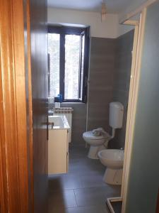 Grazioso Bilocale in Val Vigezzo في Craveggia: حمام مع حوض ومرحاض ونافذة