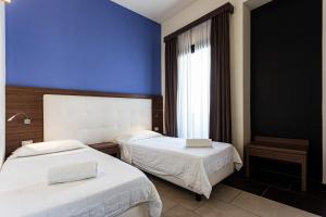 Postel nebo postele na pokoji v ubytování Hotel Don Giovanni