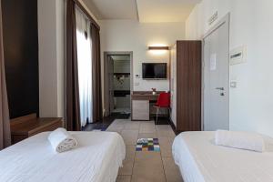 Postel nebo postele na pokoji v ubytování Hotel Don Giovanni
