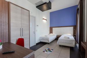 Postel nebo postele na pokoji v ubytování Hotel Don Giovanni
