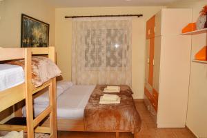 a bedroom with two bunk beds and a window at White Sea View Apartment Velipoje in Velipojë