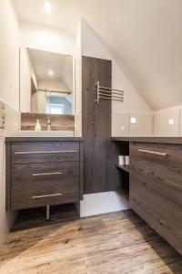 a bathroom with a sink and a mirror at Appartementhaus Alte Post in Langeoog