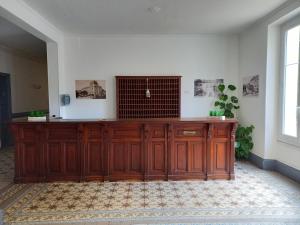 a large wooden cabinet in a room with a window at Studio 253, classé 2 étoiles, proche des thermes in Vittel +2 photos