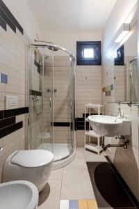 ein Bad mit einer Dusche, einem WC und einem Waschbecken in der Unterkunft Hotel Don Giovanni in Avola