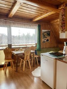 a kitchen and dining room with a table and chairs at Dom Gościnny U LEONA in Zakopane