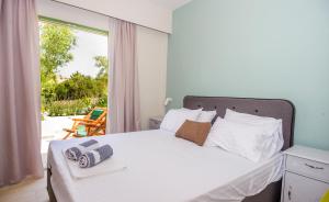 Postel nebo postele na pokoji v ubytování tzogias apartments pan + 35 fotografií