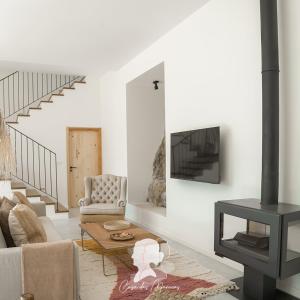 a living room with a couch and a fireplace at Casa das Marucas in Peso da Régua
