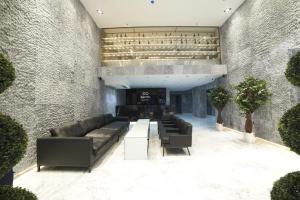 a living room with a couch and a fireplace at En Otel Karaca in Eskisehir